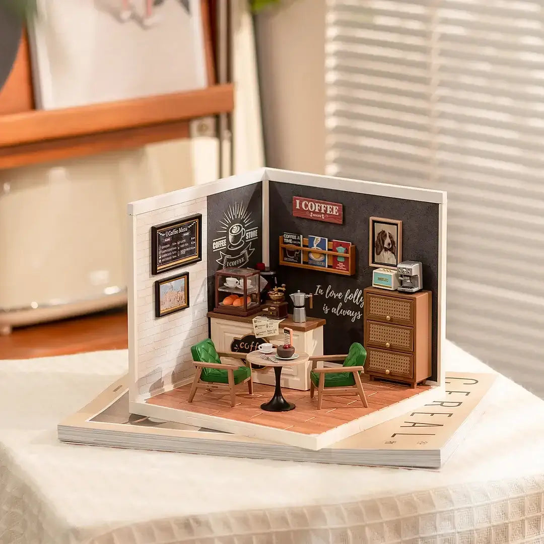 Daily Inspiration Cafe DIY Plastic Miniature House displayed on table, featuring miniature furniture and decor for a cozy cafe scene.