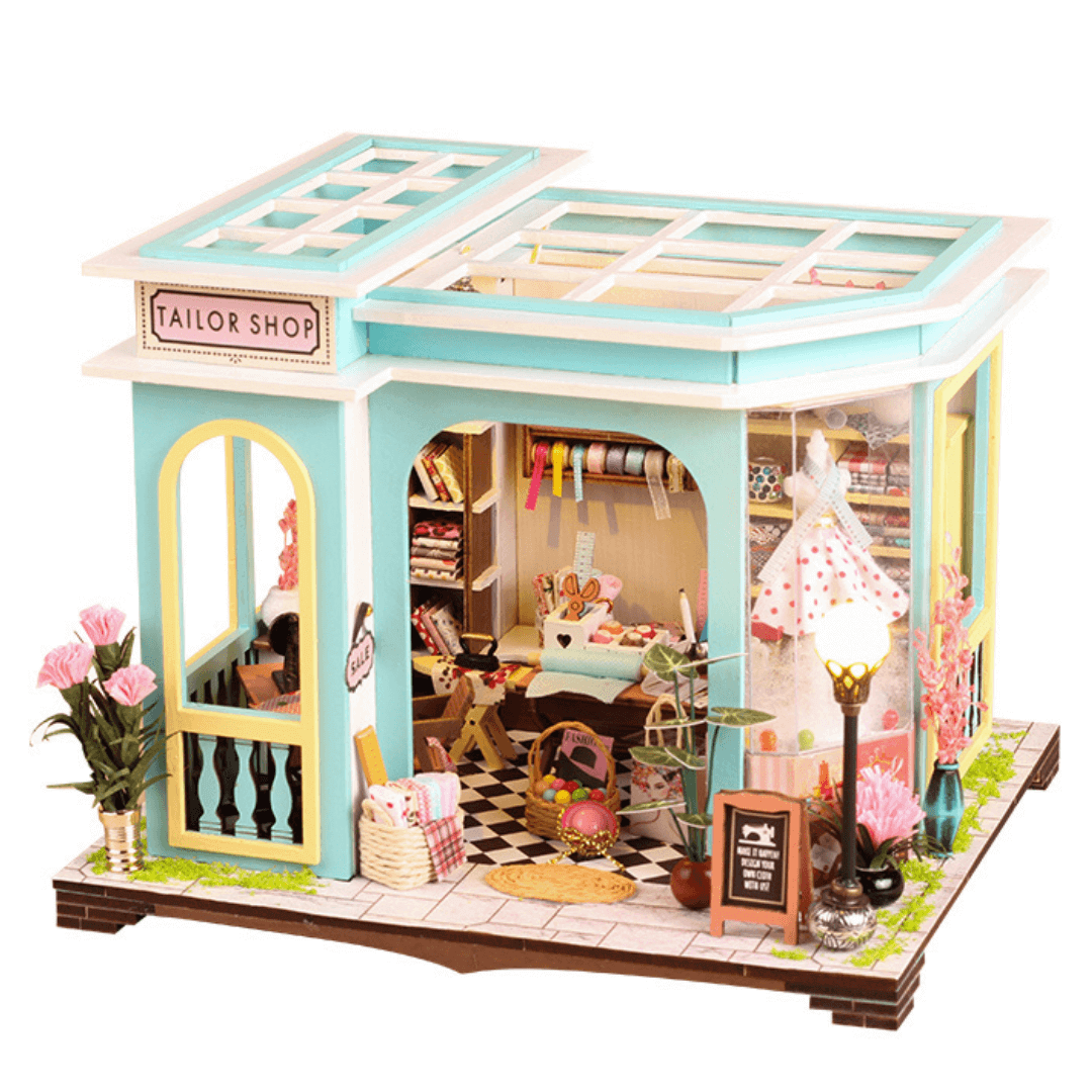 Tailor Shop Dollhouse Kit miniature house with teal accents, detailed interior, and floral decorations, perfect for crafting and display.