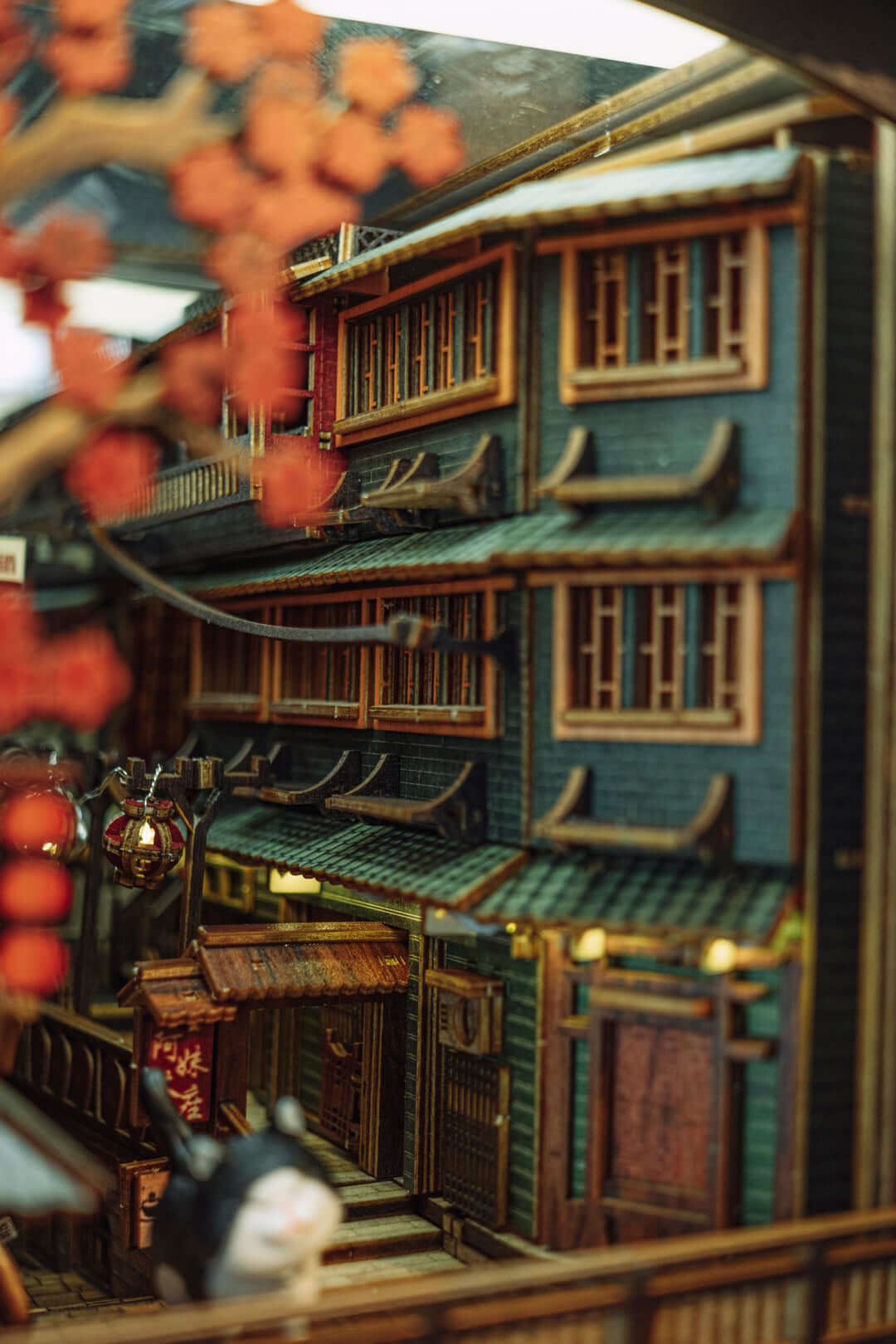 JiuFen Old Street DIY book nook kit featuring traditional Chinese architecture with cherry blossoms and vibrant lanterns.